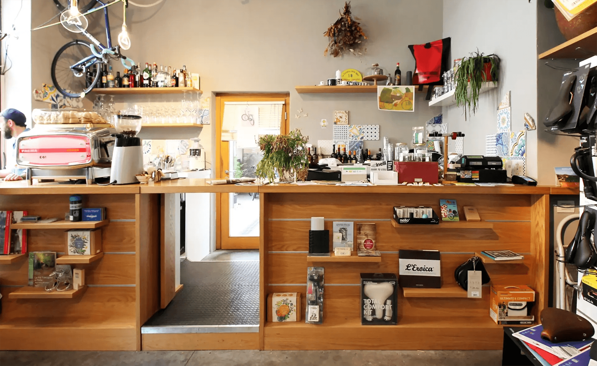 Front view of counter with cycling accessories, books and artisan products on display